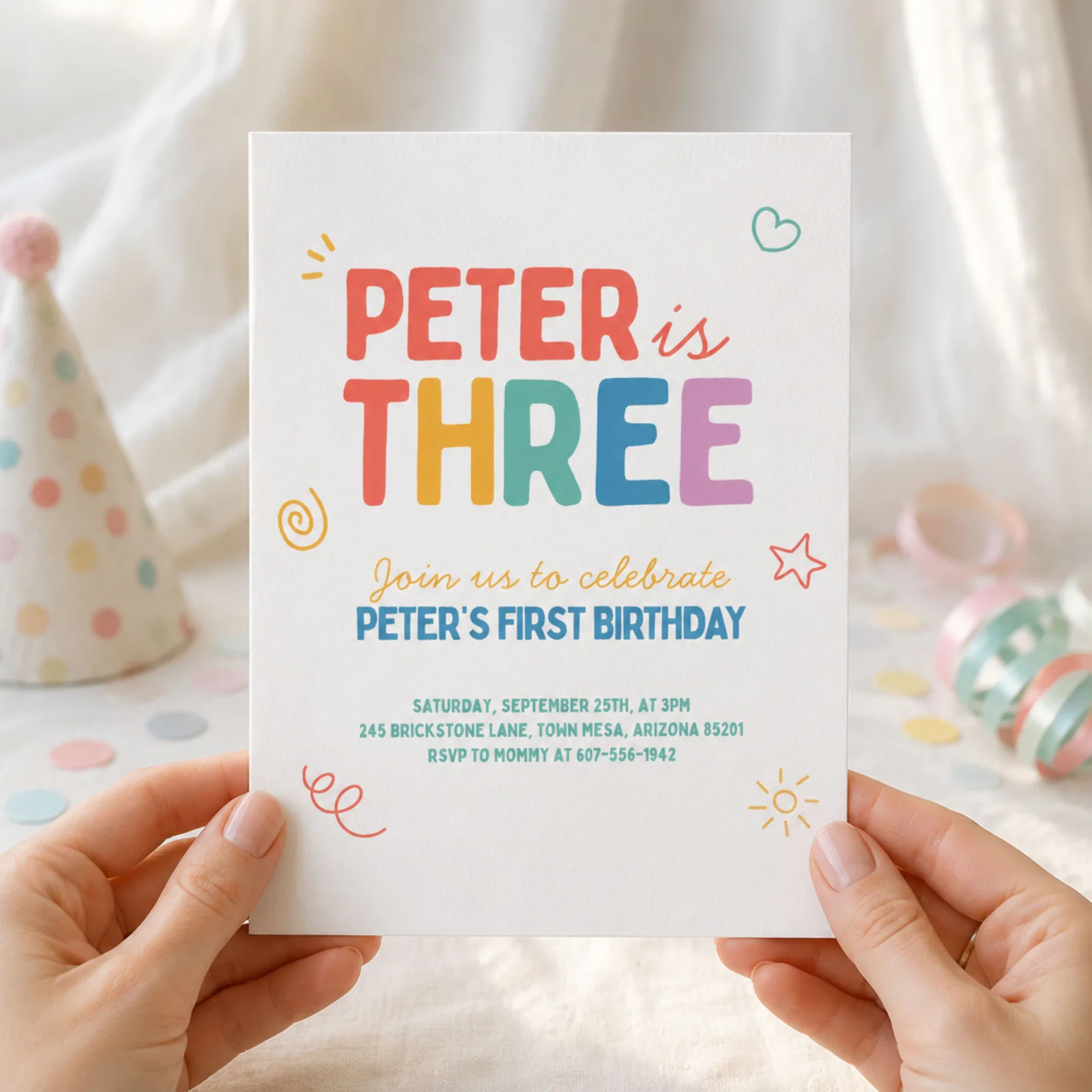 Colorful Kids Birthday Invite held in hands, showcasing rainbow doodles and cheerful design, an editable Canva template.