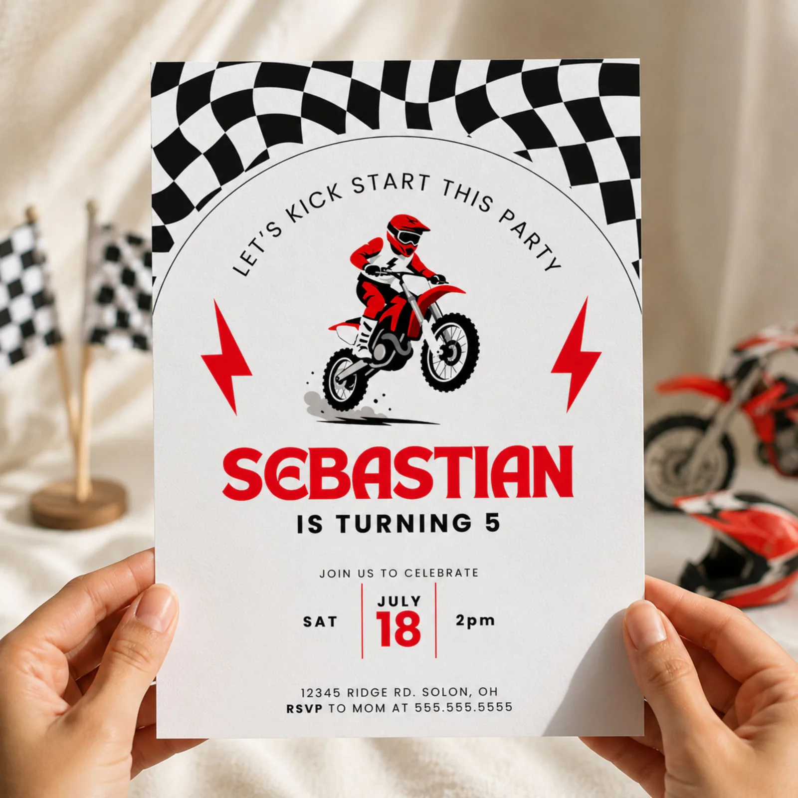Dirt Bike Birthday Invitation held in hands, a lifestyle hero shot of the motocross themed editable Canva template.