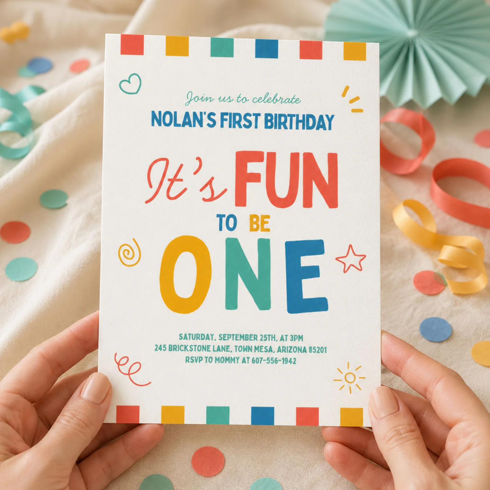 Fun To Be One Birthday Invitation held in hands, a colorful boy 1st birthday invite with doodles.