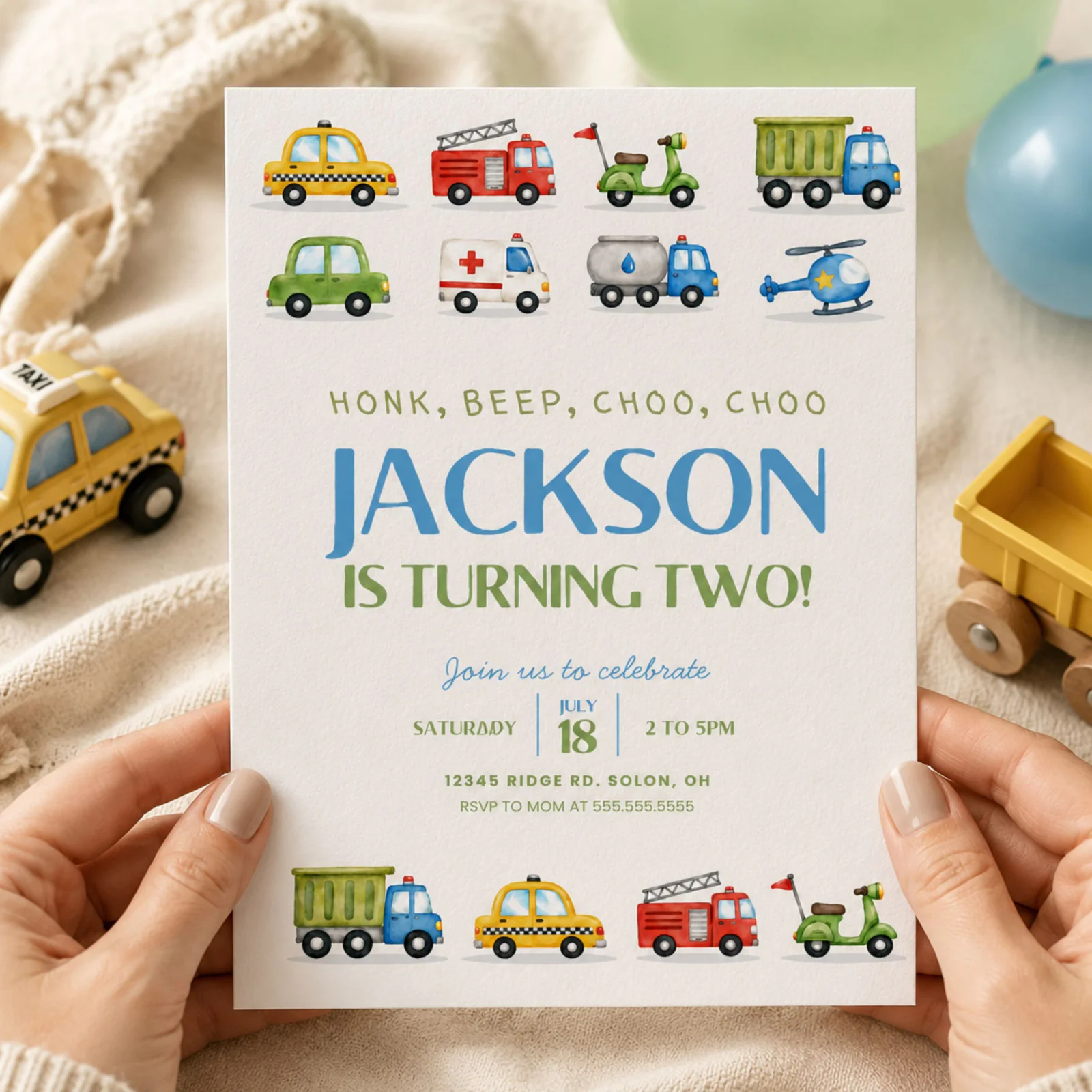 Transportation birthday invitation held in hands, featuring watercolor cars, trucks, and trains. Editable Canva template.