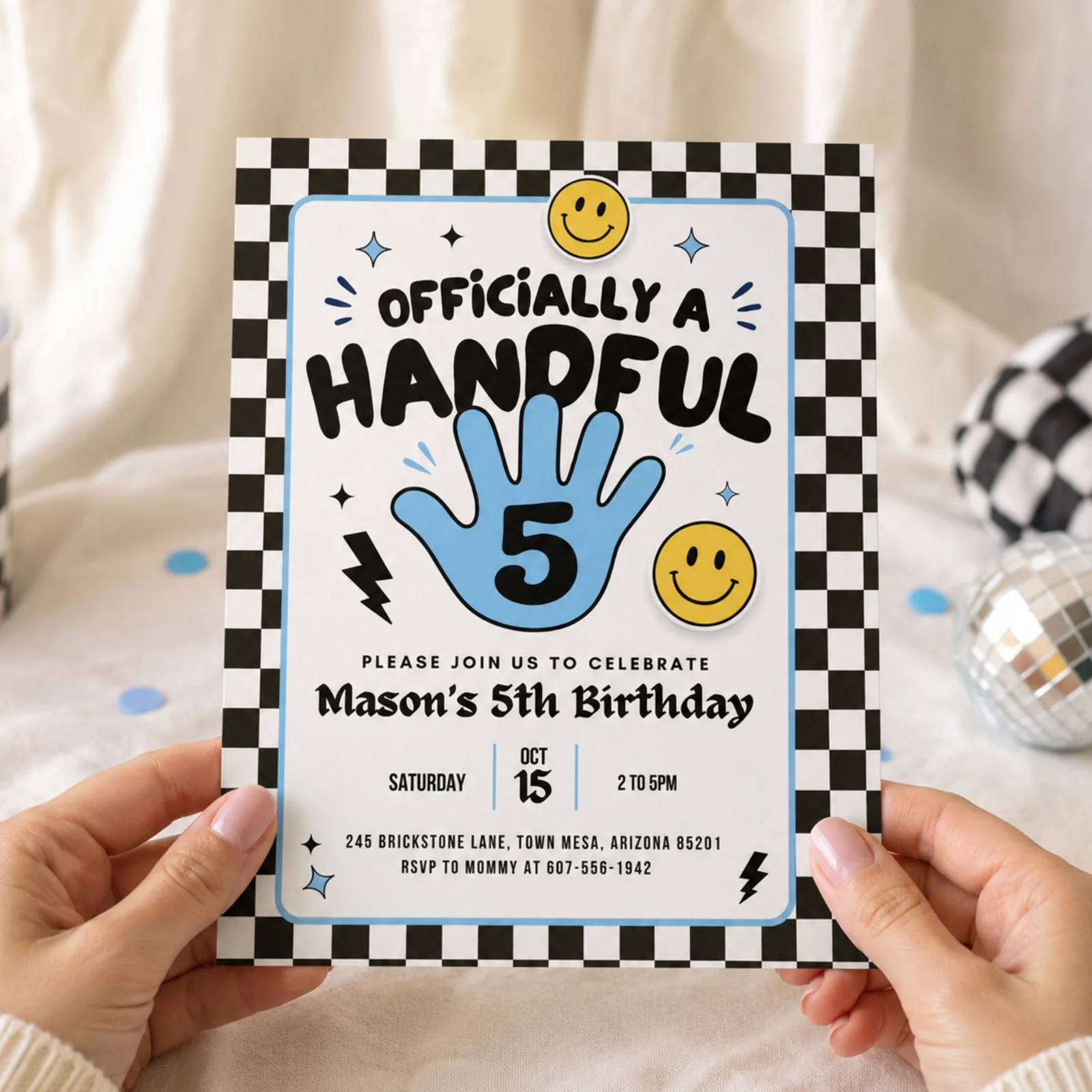 Officially A Handful 5th birthday invitation held in hands, featuring a blue handprint, checkerboard border, and smiley faces, editable Canva template.